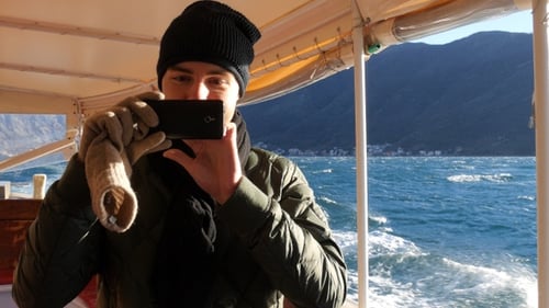 Tourist with Mobile Phone on Boat in The Sea Taking Pictures