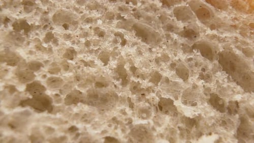 Background of a Slice of Freshly Baked White Bread, Macro Shot Golden Bread Structure