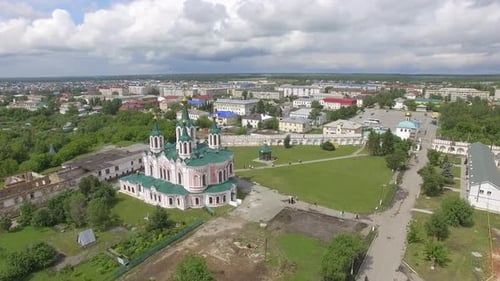 Aerial view monastery surrounded by a brick wall on the edge of the city 09
