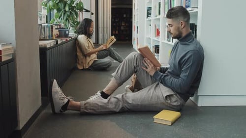 People Reading on Floor in Library