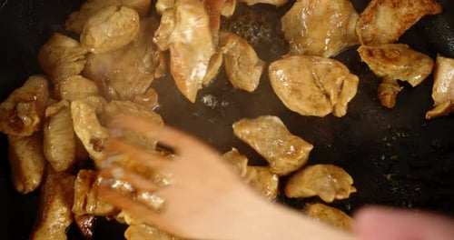 Chicken Pieces Sizzling in a Pan