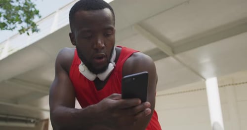 Young Adult Exercising with Phone in Urban Setting