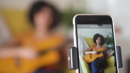 Woman Plays Guitar at Home Close Up