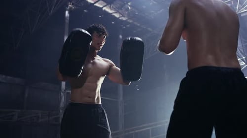 4K Asian man boxer do practicing boxing with male coach in abandoned building.