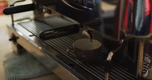 Espresso Being Prepared in a Metal Coffee Machine