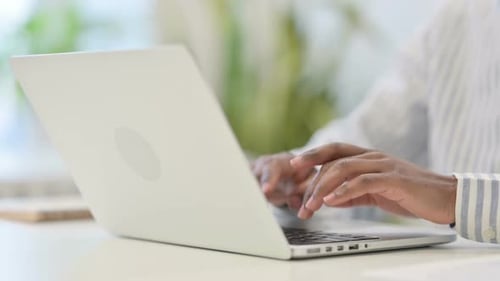 Close Up of African Man Working on Laptop