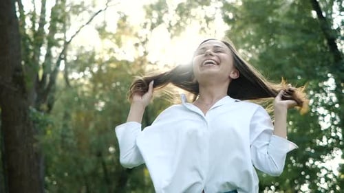 Close Up Portrait of Young Brunette Girl Smiling. Happy Awesome Woman with Hair Blowing in Wind