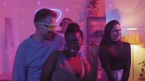 Friends Dancing at a Neon Lit House Party