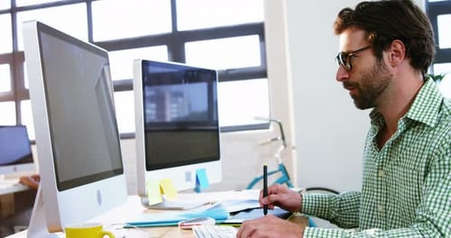 Man Working on Graphics Tablet in Modern Office