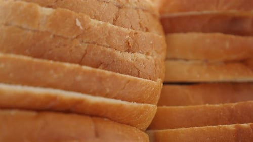 Fresh toasting bread pieces close-up food background slow tilt 4K 2160p 30fps UHD footage - Tilting