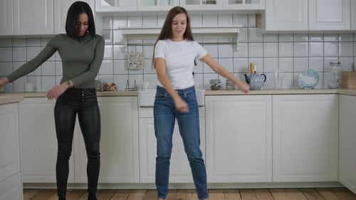 Two Women Dancing in a Modern Kitchen