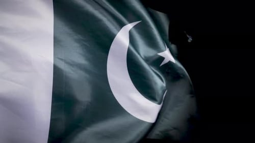 Pakistani Flag Waving Against Black Background
