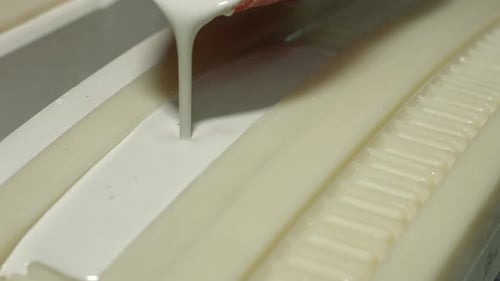 White Liquid Being Poured into a Mold
