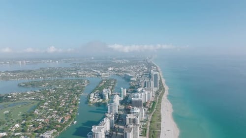 Forwards Fly Above Row of Modern High Rise Buildings Along Beach at Sea Coast