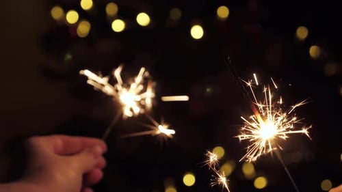 Sparklers Glowing in the Dark with Bokeh Lights