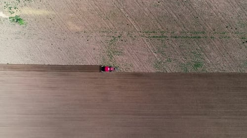 Aerial View Tractor Plows the Land, Processing the Field Before Sowing, Spring