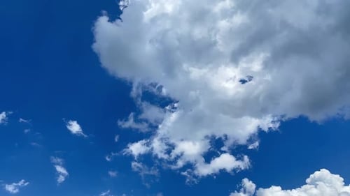 Clouds Slowly Drifting Across a Deep Blue Sky