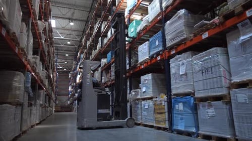 Forklift Picks Up Goods From the Shelf