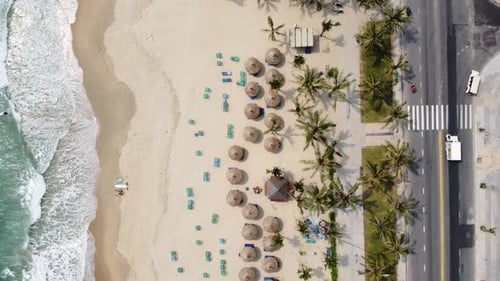 Aerial View of a Wonderful White Sand Beach with Waves Brushing on the Shore Road and Moving