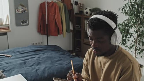 Young Adult Studying with Laptop at Desk