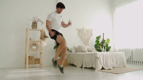 Young Man Doing High Knees Exercise at Home