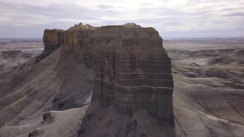 Aerial view circling tall rock spires in the desert