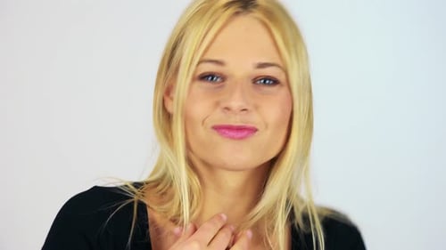 A Young Attractive Woman Dances While Looking at the Camera - Face Closeup - White Screen Studio