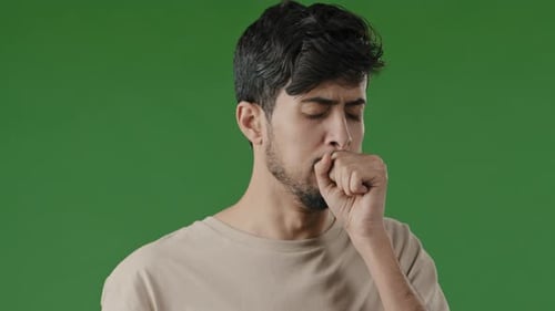 Young Adult Man Coughing on Green Screen