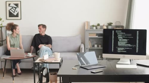 Programmers Having Conversation at Home Office