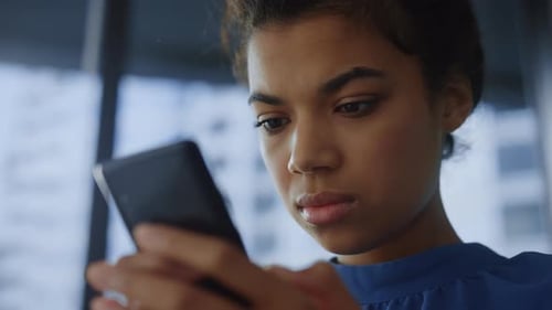 Businesswoman Typing on Smartphone