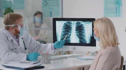 Doctor Explains X-Ray to Patient in Hospital