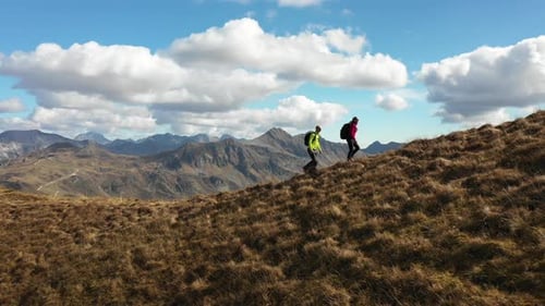 Aerial View Two Hikers Walking up Mountain Ridge