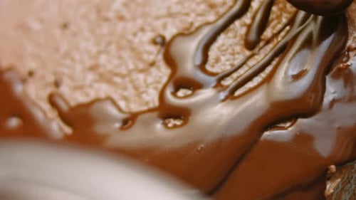 Melted Chocolate Pouring with a Spoon, Close Up