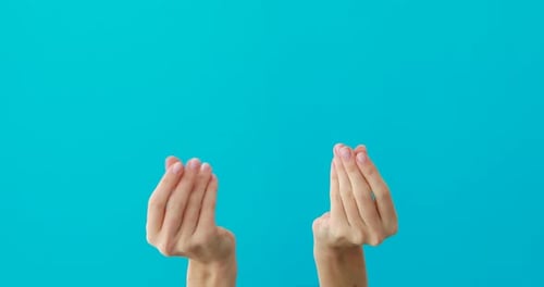 Hands Making Pinching Gesture in Front of Blue Screen