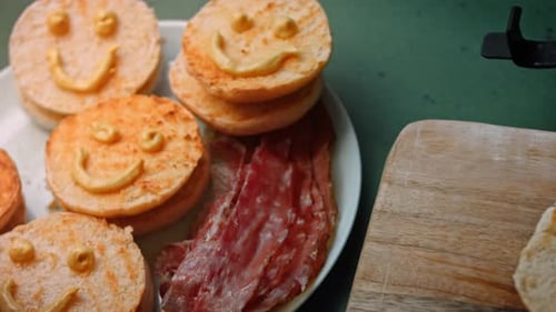Cheeseburgers Cooking on Grill, Buns with Smiley Faces