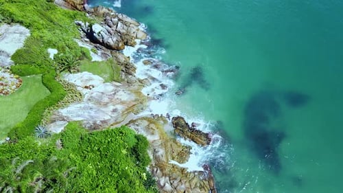 Drone footage of a small beach. Slow Downward Camera Movement.