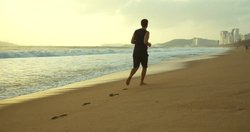 Young Caucasian Man Are Exercising with Outdoor Running with a Beautiful Sea Background