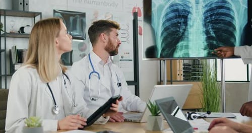 Female Doctors Examining Results of Chest Radiography on Digital Screen in Medical Office