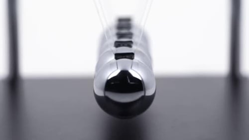 Chrome Newton's Cradle Swinging in Perpetual Motion