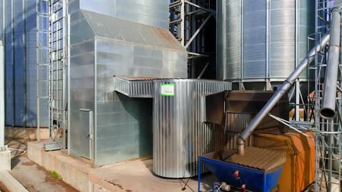 Elevator for storing agricultural products. Aerial view of drone on large granary in field