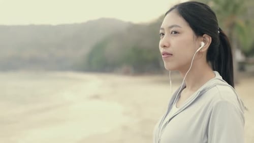 Woman Listening to Music at the Beach