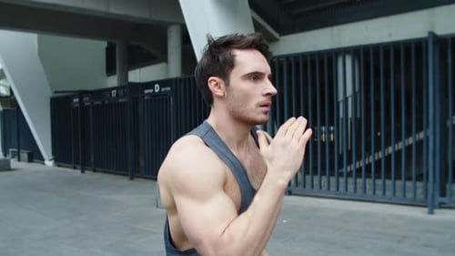 Closeup Fit Man Running on Urban Street. Close Up Male Runner Jogging Outdoor.