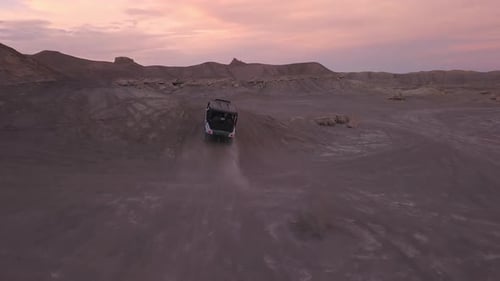 Following OHV driving over hill in the desert