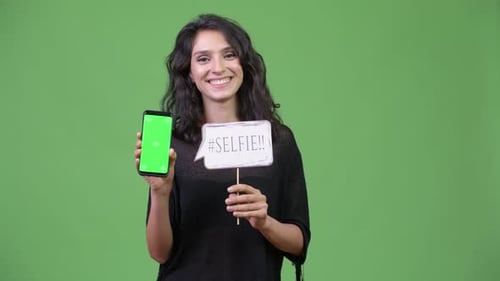 Woman Holding Phone and Selfie Prop Smiling
