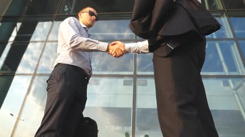 Two Businessmen Meeting Near Office Building and Greeting Each Other. Business Handshake Outdoor in