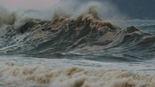 Big Wave with Foam and Dirt Breaks on the Shore During Strong Storm in the Atlantic Ocean