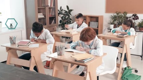 Children Studying at Desks in Science Classroom