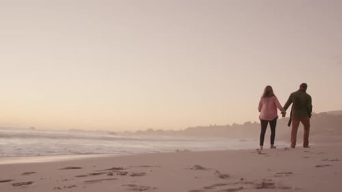 Active senior couple walking on beach