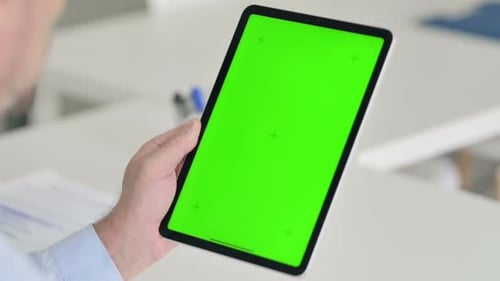 Middle Aged Man Using Tablet with Green Chroma Screen