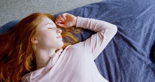 Woman Sleeping Soundly on a Bed at Home